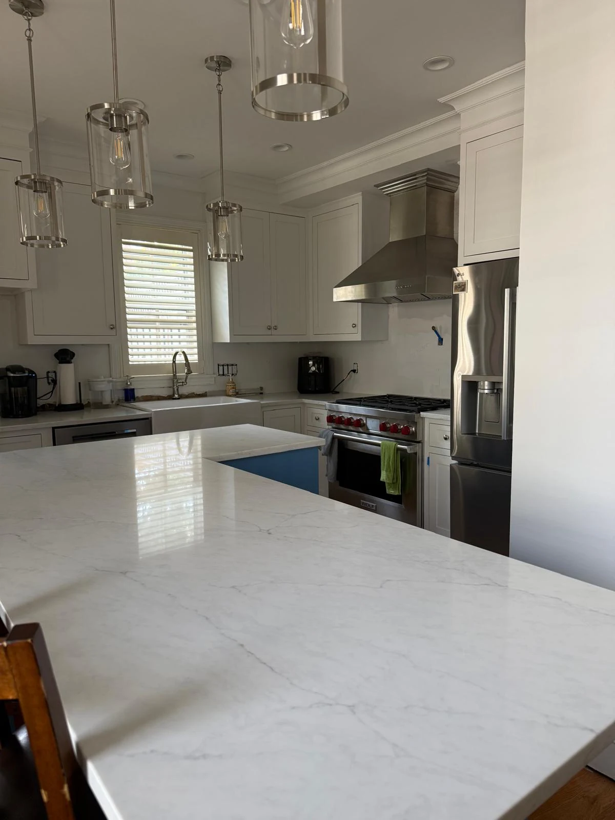 Professionally cleaned kitchen with a large spotless island and bright counters